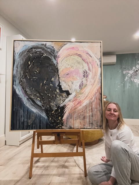 Niki with one of her large heart paintings in the studio